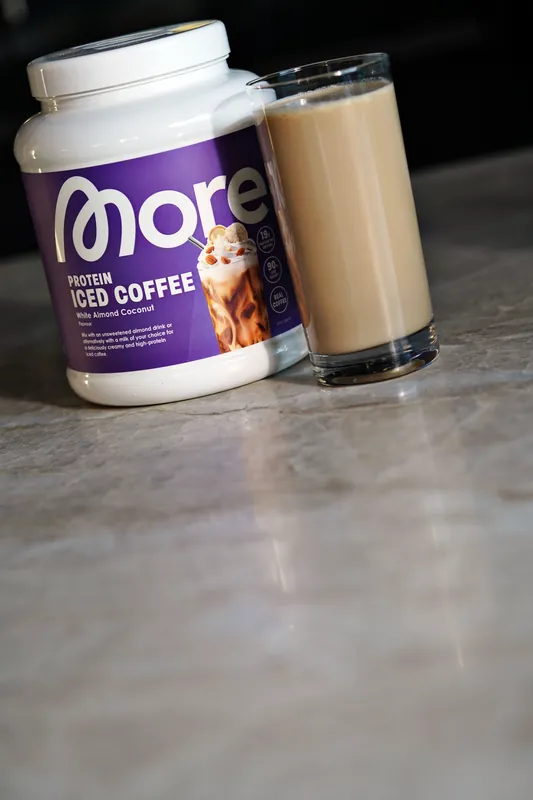 More Protein Iced Coffee – White Almond Coconut, with a glass